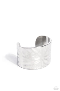 A thick band of silver, featuring warped textures across its surface wraps around the wrist for a standout centerpiece, reflecting light off every fold. Sold as one individual bracelet.