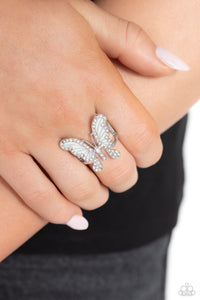 Sparkling with dainty, round iridescent rhinestones, a silver butterfly with white wings, fearlessly flutters atop the finger for a statement-making finish. Features a stretchy band for a flexible fit. Due to its prismatic palette, color may vary.  Sold as one individual ring.