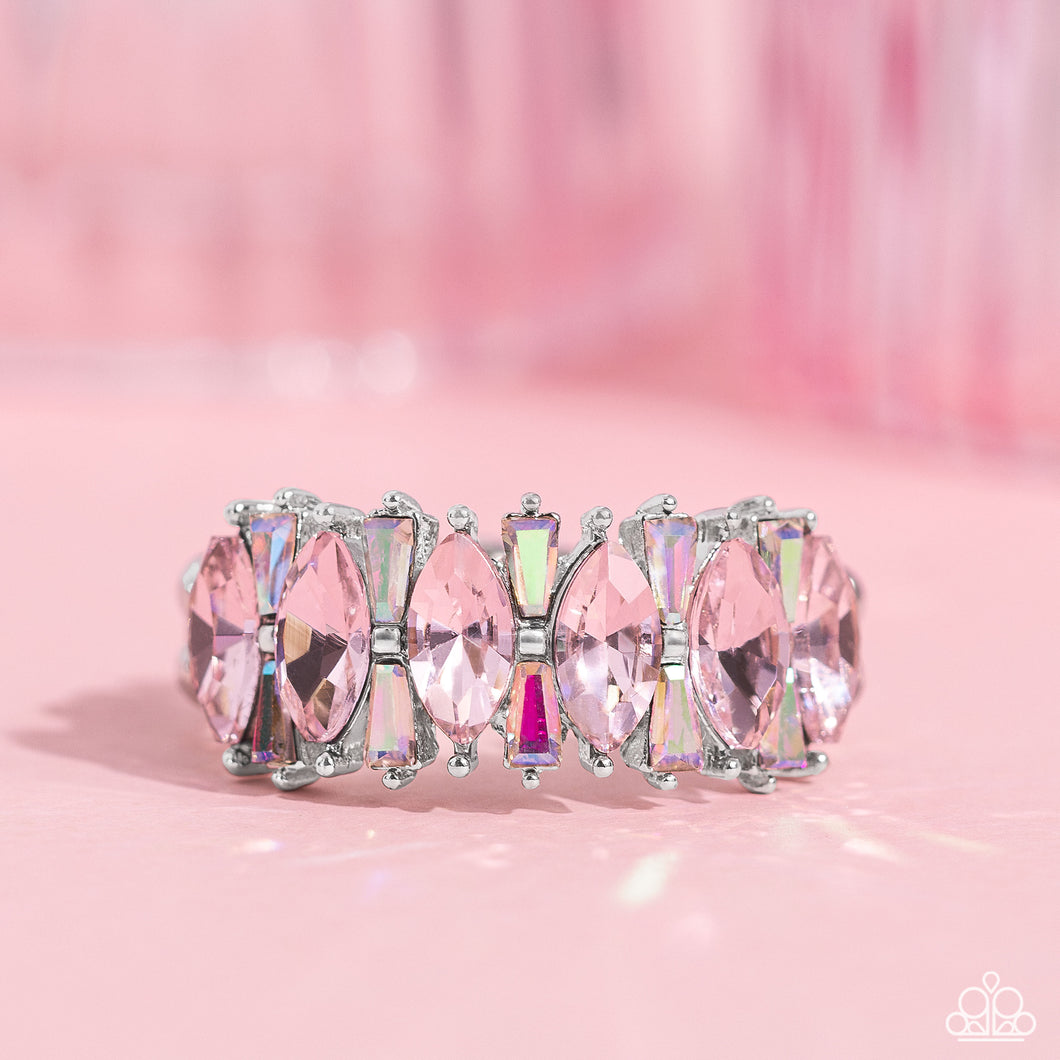 A row of glassy pink marquise-cut rhinestones, encased in dainty silver-pronged fittings, alternate with dainty iridescent rhinestone bars as they connect across the finger, creating a knockout kaleidoscope of color. Features a dainty stretchy band for a flexible fit. Due to its prismatic palette, color may vary.  Sold as one individual ring.