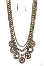 Load image into Gallery viewer, Brass gear pendants with varying textures, details, sizes, and a dusting of white rhinestones, swing from a thick brass curb chain, creating a steampunk-like fringe. A brass snake chain and an additional brass curb chain combine with the grungy, industrial display for additional sheen and attitude. Features an adjustable clasp closure.  Sold as one individual necklace. Includes one pair of matching earrings.
