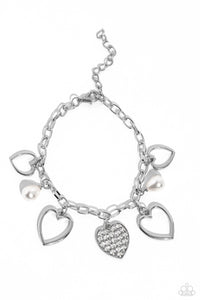 Glistening silver heart silhouettes, white potato pearls, and a white rhinestone-encrusted silver heart frame dangle from a classic silver chain link around the wrist, resulting in a romantic fringe. Features an adjustable clasp closure.  Sold as one individual bracelet
