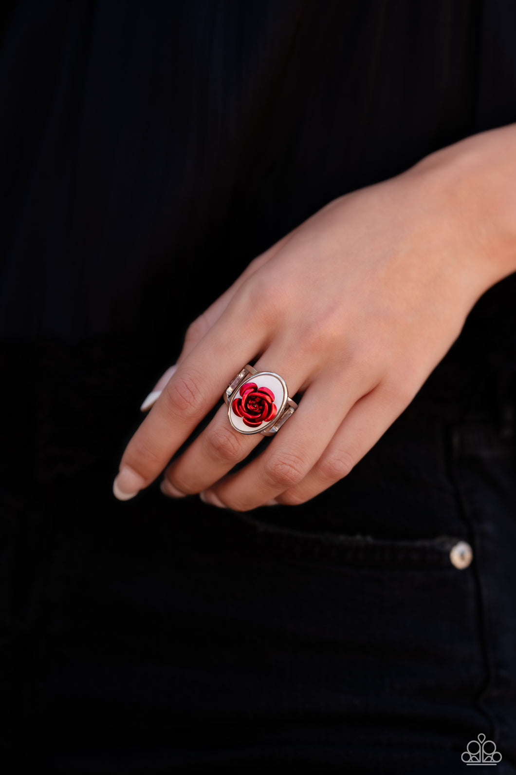 Featuring a white shell backdrop, high-sheen red petals fan out from the center of the oval display, creating a regal rose atop airy silver bands on the finger. Features a stretchy band for a flexible fit.  Sold as one individual ring.