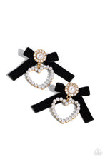 Load image into Gallery viewer, A solitaire white pearl, pressed in a white rhinestone-encrusted gold hoop, gleams atop a pearl-dotted heart frame resulting in a dazzling statement piece. A black velvet ribbon fans out from the pearly centerpiece further infusing the design with elegance. Earring attaches to a standard post fitting.  Sold as one pair of post earrings.
