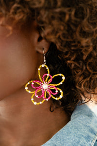 A glossy white pearl blooms from the center of a layered Pink Peacock and High Visibility glassy seed bead flower, infused with additional dainty white pearls, creating a colorful floral frame. Earring attaches to a standard fishhook fitting.  Sold as one pair of earrings.