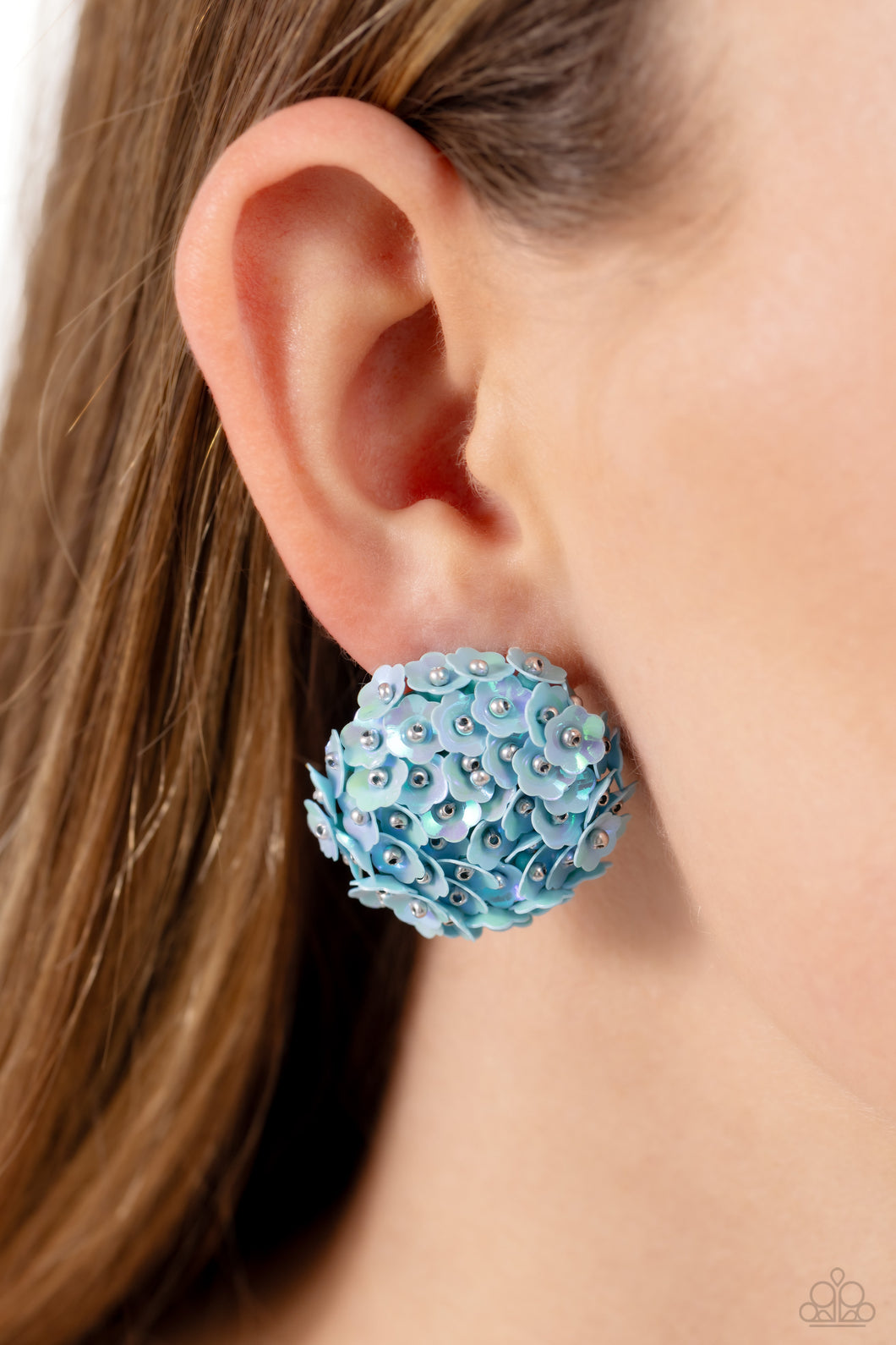 Featuring a light iridescent sheen, light blue flowers with silver stud centers explode around the ear to create a whimsical bouquet-inspired statement. Earring attaches to a standard post fitting.  Sold as one pair of post earrings.