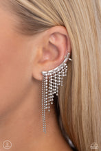 Load image into Gallery viewer, A tapered fringe of dainty silver popcorn chains and glittery strands of white rhinestones in square fittings cascades from the edge of a white emerald-cut, gem-encrusted curved frame, creating an edgy centerpiece. Earring attaches to a standard post earring. Features a clip-on fitting at the top for a secure fit.  Sold as one pair of ear crawlers.
