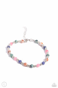 Infused with silver accents and floral beads, a colorful collection of natural stones are threaded around the ankle for a tranquil look. As the stone elements in this piece are natural, some color variation is normal. Sold as one individual anklet.