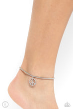 Load image into Gallery viewer, A silver peace sign infused with dazzling white rhinestones effortlessly slides along a thick silver snake chain, creating an irresistible pendant. Features an adjustable clasp closure. Sold as one individual anklet.
