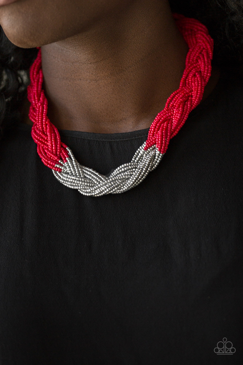 Strands of red seed beads create an indigenous braid below the collar. The red seed beads gradually morph into metallic silver beads at the center for a chic contrasting look. Features an adjustable clasp closure. Sold as one individual necklace. Includes one pair of matching earrings.