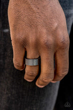 Load image into Gallery viewer, A thick gunmetal band is lined in stacked linear textures for a sleek metro look. Features a stretchy band for a flexible fit.  Sold as one individual ring.
