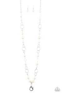 A refined collection of glassy white gems, textured silver rings, and pearly white beads drape across the chest for a timeless look. A lobster clasp hangs from the bottom of the design to allow a name badge or other item to be attached. Features an adjustable clasp closure.  Sold as one individual lanyard. Includes one pair of matching earrings.