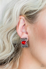 Load image into Gallery viewer, Brushed in an antiqued shimmer, vine-like filigree climbs into a glistening silver hoop. A glittery red rhinestone is pressed into the top of the frame for a regal finish. Earring attaches to a standard clip-on fitting.  Sold as one pair of clip-on earrings.
