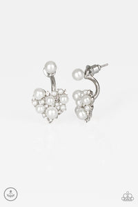 A solitaire white pearl attaches to a double-sided post, designed to fasten behind the ear. Radiating with dainty white rhinestones and matching pearls, the heart-shaped double sided-post peeks out beneath the ear for a refined look. Earring attaches to a standard post fitting.  Sold as one pair of double-sided post earrings.