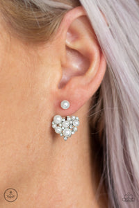 A solitaire white pearl attaches to a double-sided post, designed to fasten behind the ear. Radiating with dainty white rhinestones and matching pearls, the heart-shaped double sided-post peeks out beneath the ear for a refined look. Earring attaches to a standard post fitting.  Sold as one pair of double-sided post earrings.