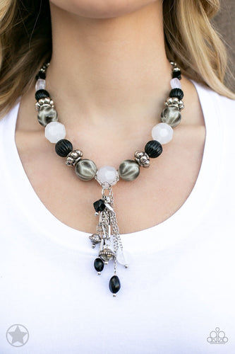 Smooth beads with a marbleized black and white swirl alternate with milky white and silver accents. A tassel of chains in various lengths is decorated with black, silver, and frosty pieces. Features an adjustable clasp closure.  Sold as one individual necklace. Includes one pair of matching earrings.