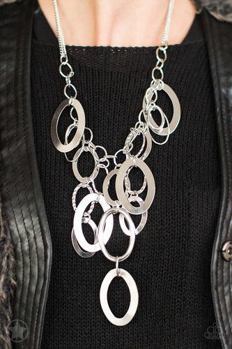 Large silver links and shimmering textured silver rings cascade below a silver chain freely, allowing for movement that makes a bold statement. Features an adjustable clasp closure. Sold as one individual blockbuster necklace. Includes one pair of matching earrings. 